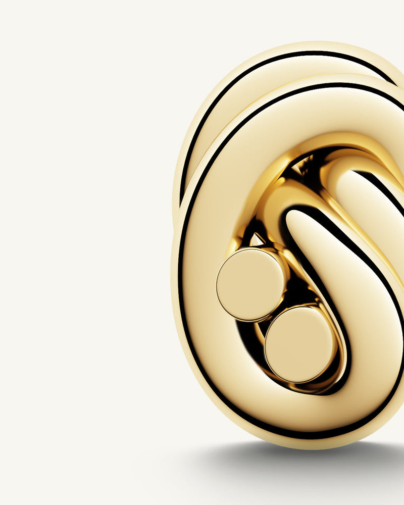 Earrings in gold plated-316L stainless steel from Waldor & Co. The model is Dual Knot Earring Polished.