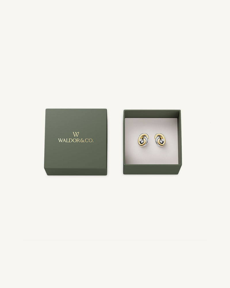 Earrings in silver and gold plated-316L stainless steel from Waldor & Co. The model is Dual Knot Earring Polished.