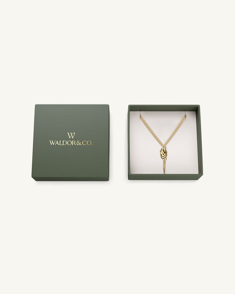 Necklace in gold plated-316L stainless steel from Waldor & Co. The model is Dual Knot Necklace Polished.