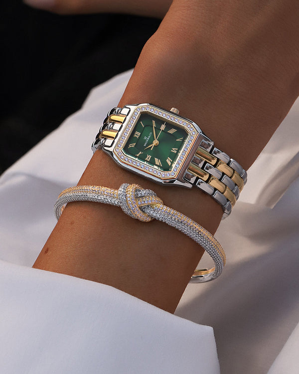 A square womens watch in Rhodium-plated 316L stainless steel from Waldor & Co. with emerald green dial. Bezel with premium crystals. Diamond Cut Sapphire Crystal glass dial. Seiko movement. The model is Eternal 22 Bellagio Pavè.
