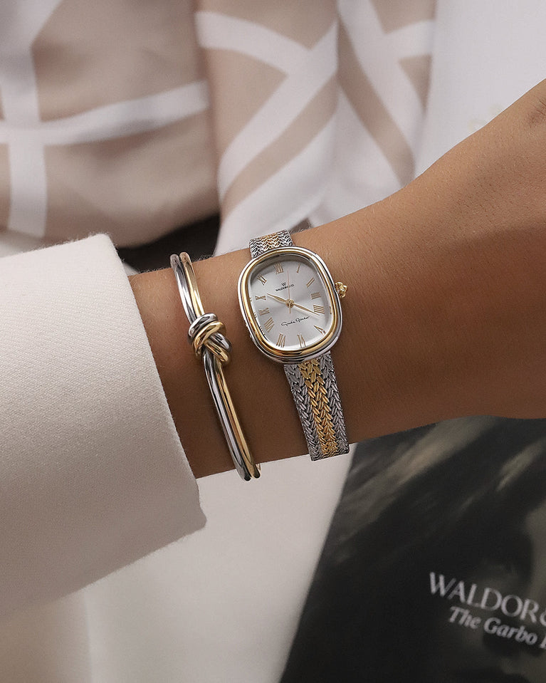 An ellipse shaped women’s watch in Rhodium-plated 316L stainless steel from Waldor & Co. with silver sunray dial in brass with Greta Garbo's signature. Mineral glass with sapphire crystal coating. Seiko movement. The model is Garbo 24 Stockholm.