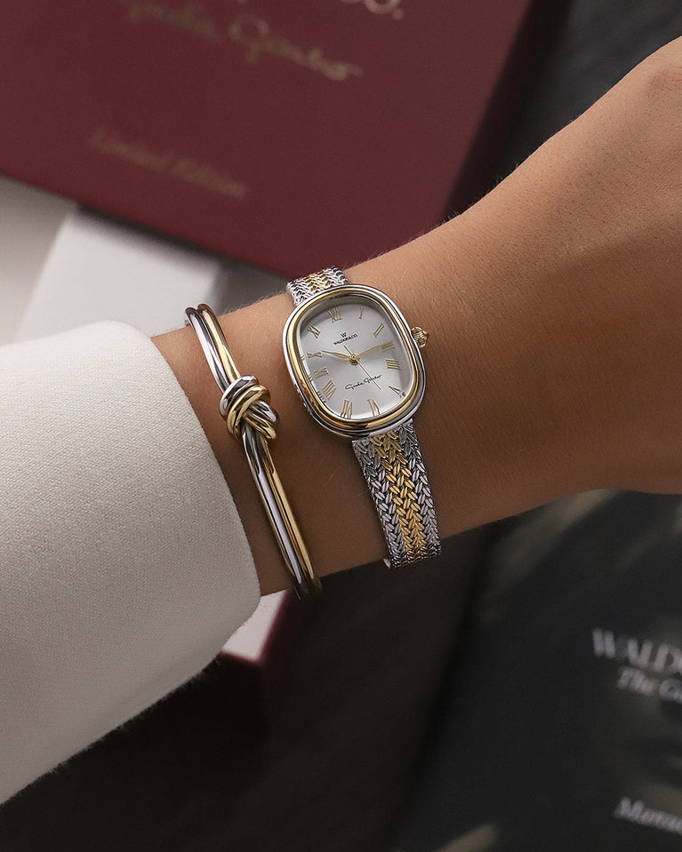 An ellipse shaped women’s watch in Rhodium-plated 316L stainless steel from Waldor & Co. with silver sunray dial in brass with Greta Garbo's signature. Mineral glass with sapphire crystal coating. Seiko movement. The model is Garbo 24 Stockholm.