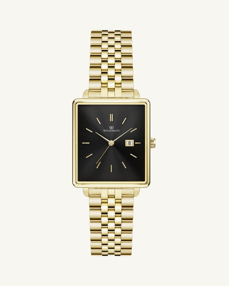 A square womens watch in 14k gold from Waldor & Co. with black sunray dial and a second hand. Seiko movement. The model is Delight 32 Chelsea 28x32mm.
