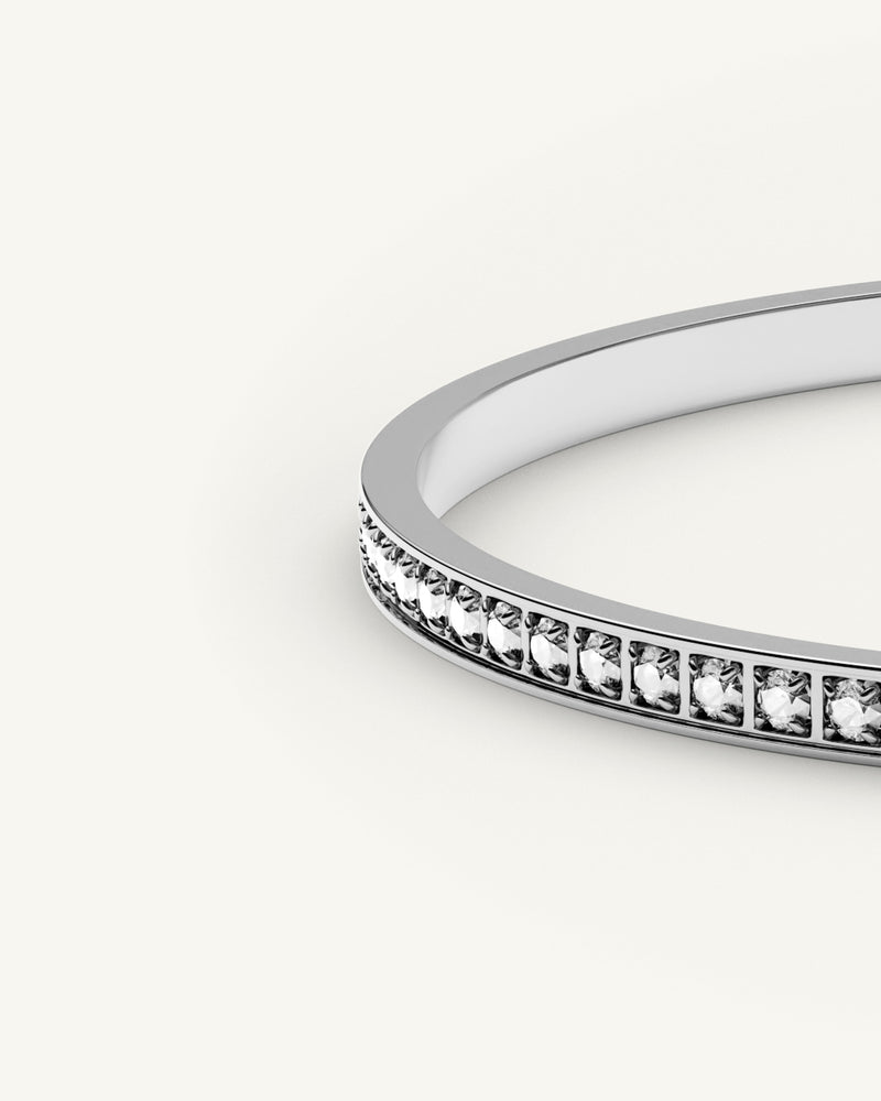 A polished stainless steel bangle in silver from Waldor & Co. One size. The model is Diamond Bangle Polished.