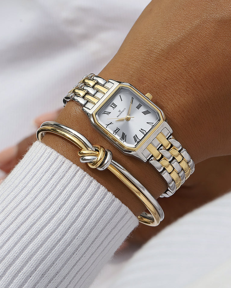 A square womens watch in 22k gold plated 316L stainless steel from Waldor & Co. with white Diamond Cut Sapphire Crystal glass dial. Seiko movement. The model is Eternal 22 Bellagio
