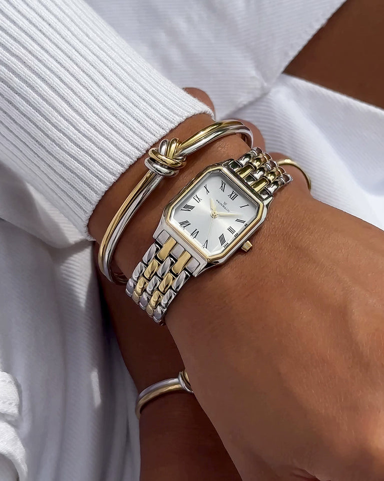 A square womens watch in 22k gold plated 316L stainless steel from Waldor & Co. with white Diamond Cut Sapphire Crystal glass dial. Seiko movement. The model is Eternal 22 Bellagio