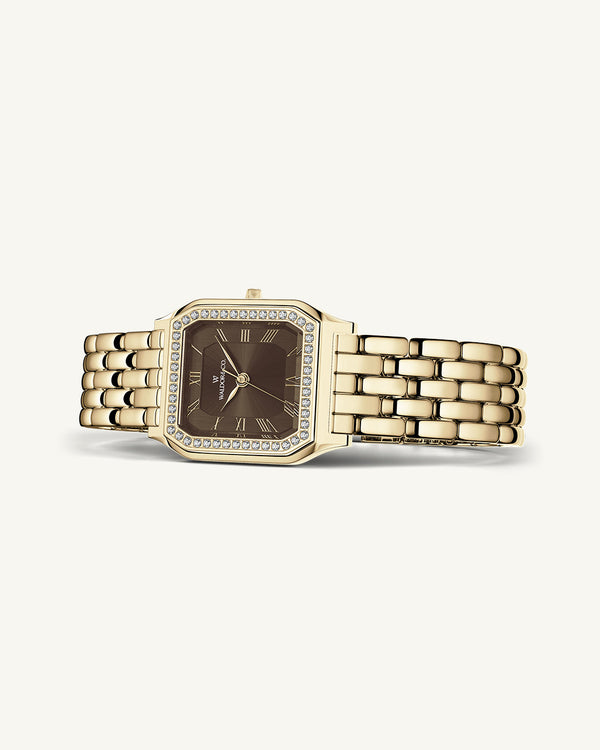 A square womens watch in Rhodium-plated 316L stainless steel from Waldor & Co. with a deep brown dial. Bezel with premium crystals. Diamond Cut Sapphire Crystal glass dial. Seiko movement. The model is Eternal 22 Bellagio Pavè.