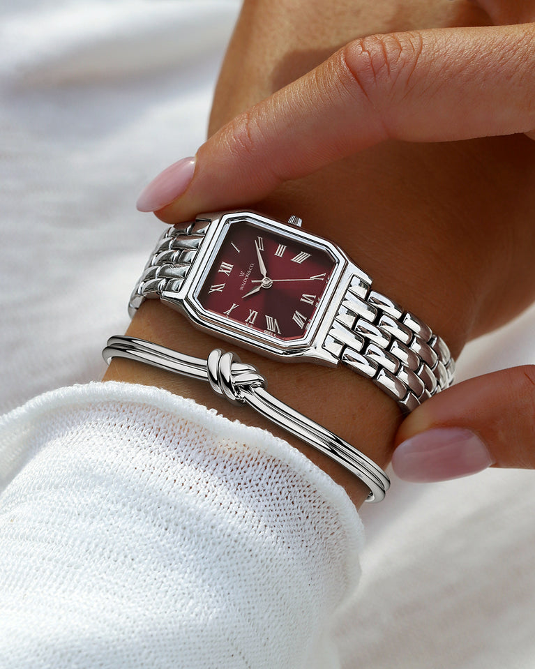 A square womens watch in Rhodium-plated 316L stainless steel from Waldor & Co. with burgundy Diamond Cut Sapphire Crystal glass dial. Seiko movement. The model is Eternal 22 Bellagio.