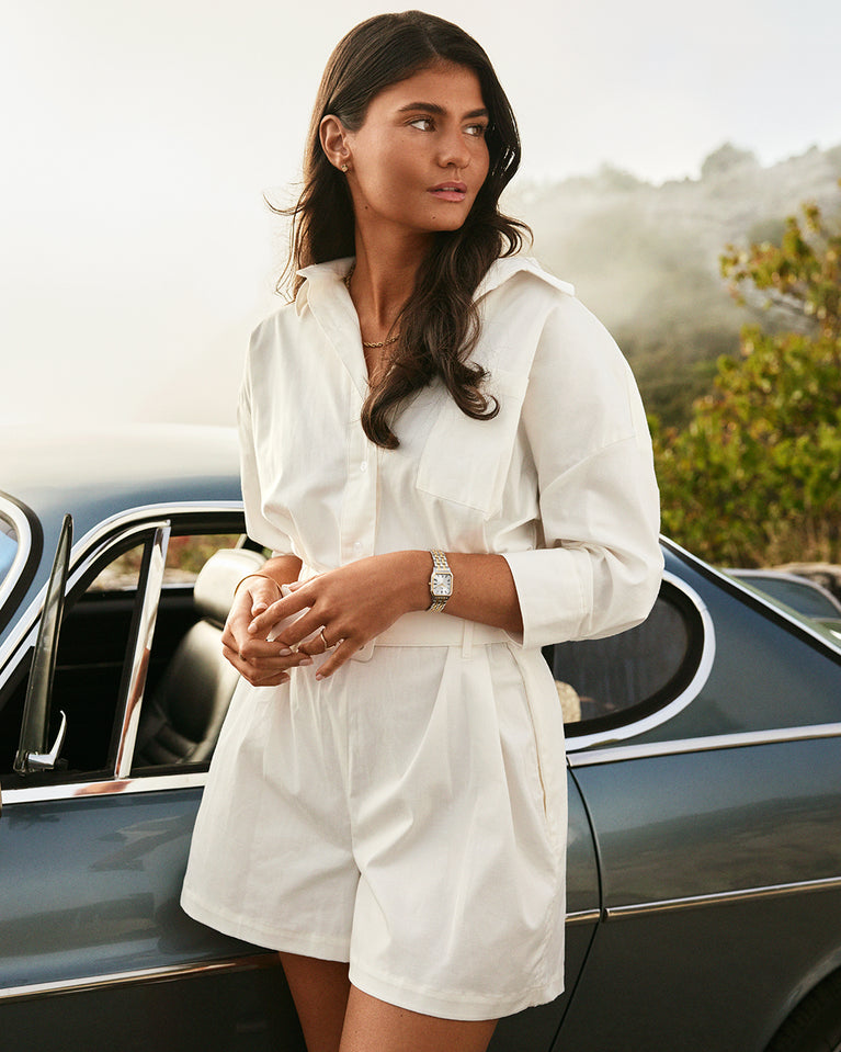 A square women’s watch and double knot bracelet in gold and silver from Waldor & co. The model is Eternal 22 Bellagio & Dual Knot Bangle.