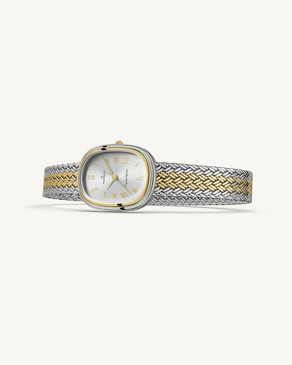 An oval womens watch created under exclusive license from the Greta Garbo™ estate. Featuring a silver sunray dial with gold Roman numerals, framed in a dual-tone case. Seiko movement. 