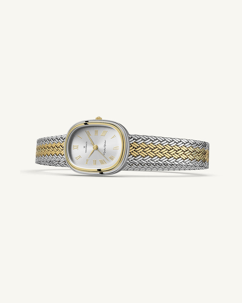 An oval womens watch created under exclusive license from the Greta Garbo™ estate. Featuring a silver sunray dial with gold Roman numerals, framed in a dual-tone case. Seiko movement. 