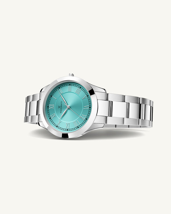 A round womens watch in silver from Waldor & Co. with turquoise sunray dial and a second hand. Seiko movement. The model is Imperial 32 Nocelle 32mm.