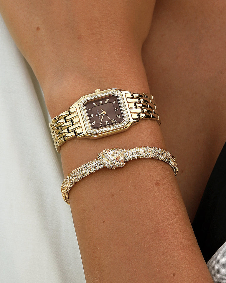  A square womens watch in Rhodium-plated 316L stainless steel from Waldor & Co. with a deep brown dial. Bezel with premium crystals. Diamond Cut Sapphire Crystal glass dial. Seiko movement. The model is Eternal 22 Bellagio Pavè.