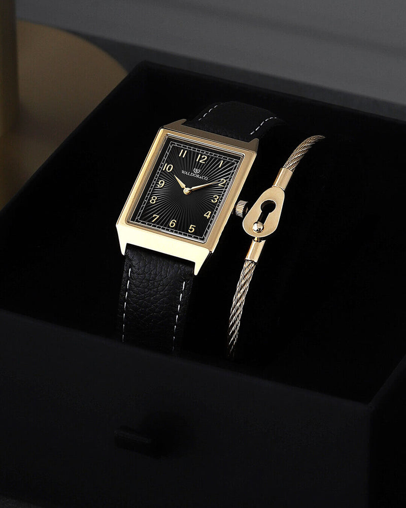 A square mens watch in 14k gold-plated 316L stainless steel from Waldor & Co. with black guilloche dial. Miyota movement. Leather strap. The model is Conceptual 37 Cap Ferrat.